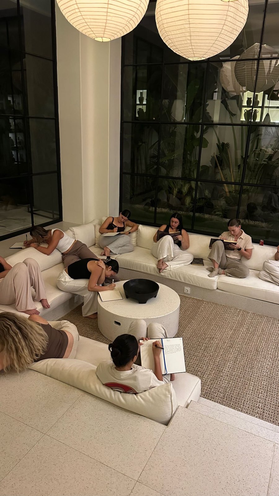 Women journaling together in the SŌMA space